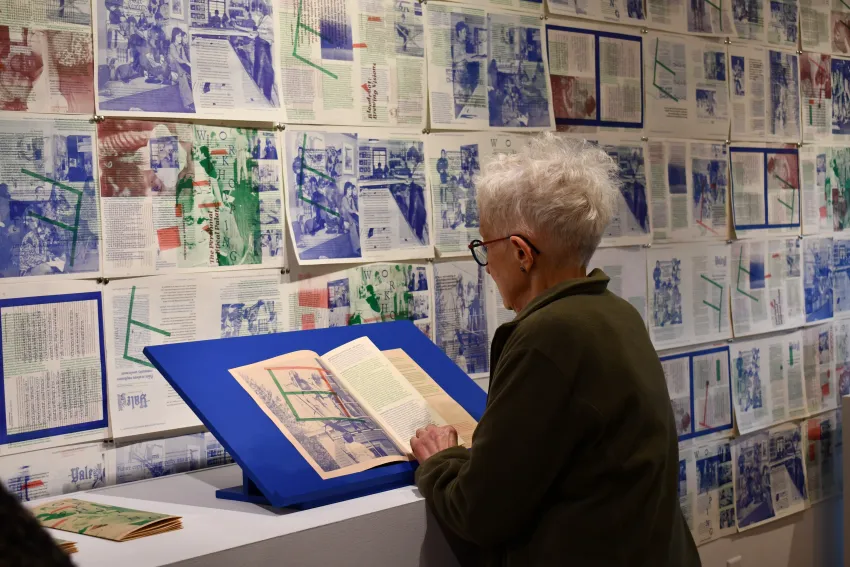 exibition view of Workshopping, showing WSW founder Tatana Kellner looking at the publication